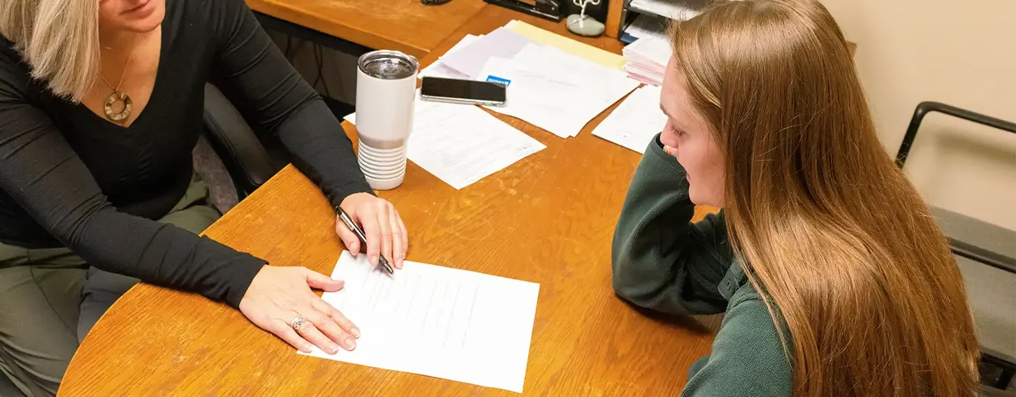 A student meeting with an advisor in an office